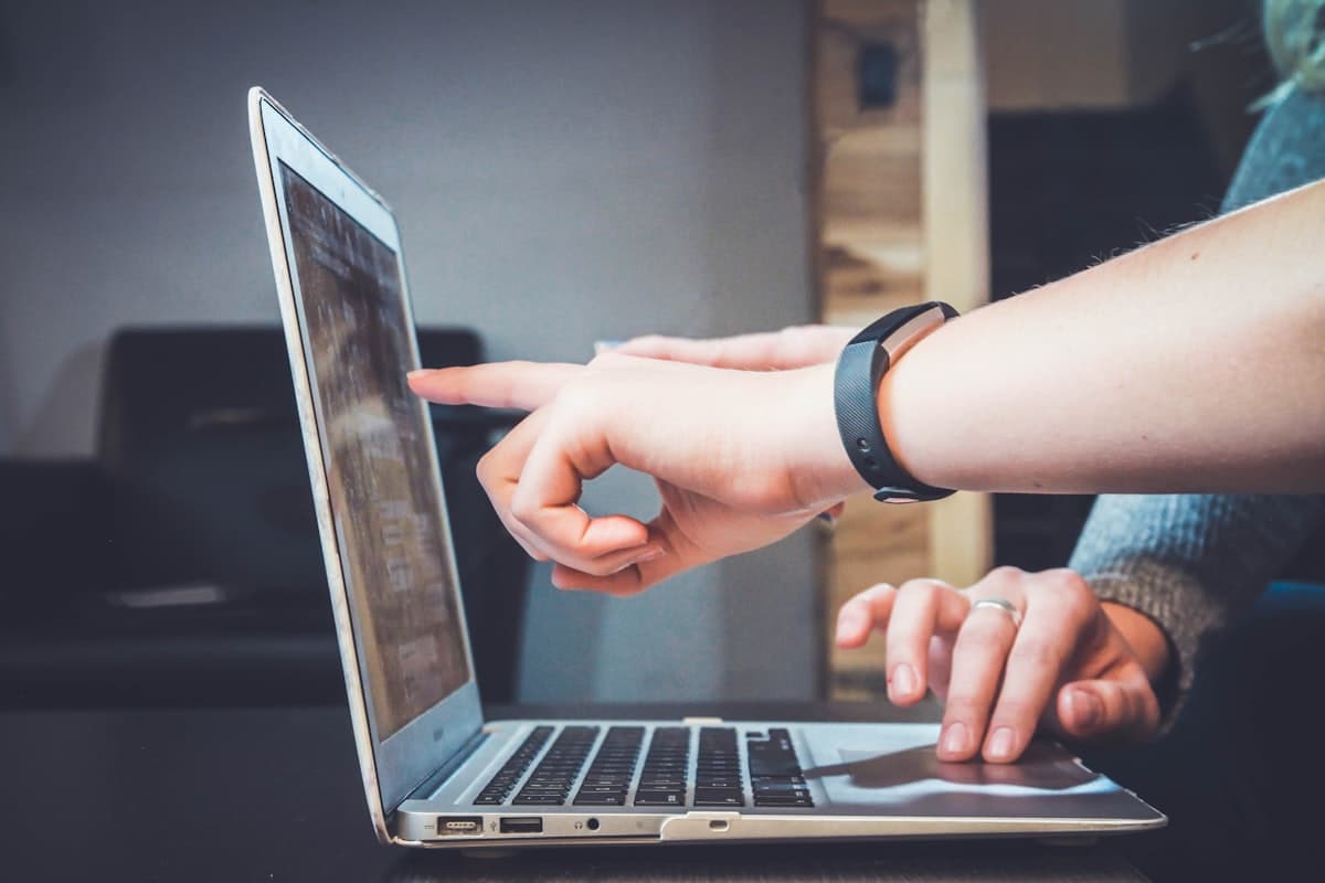 People collaborating with laptops in a live conversation setting